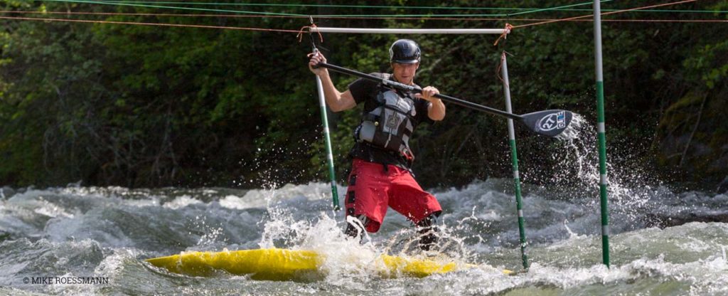 Man competing in river kayak race