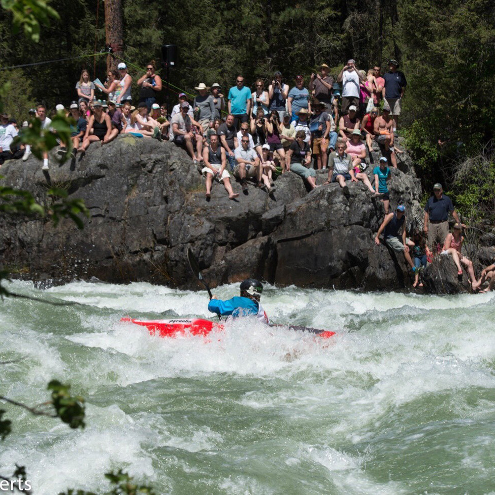 Whitewater race men kayaking in rushing river