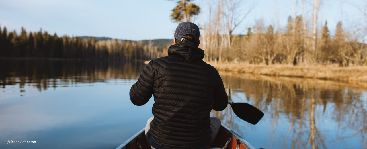 Man canoeing on lake