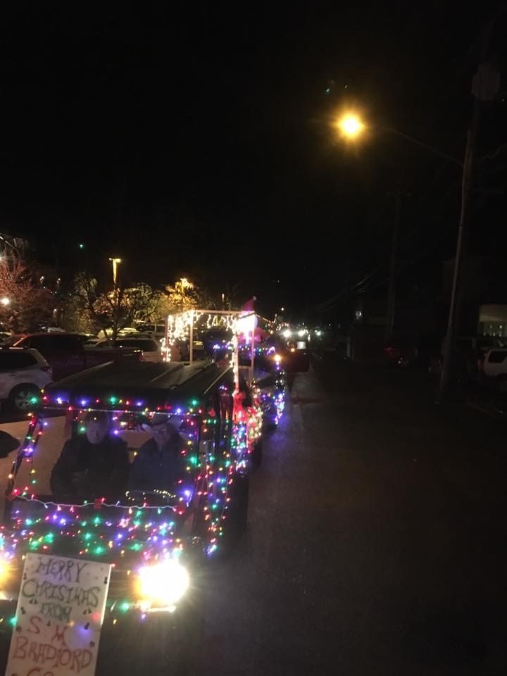 Cars decorated with holiday lights for parade