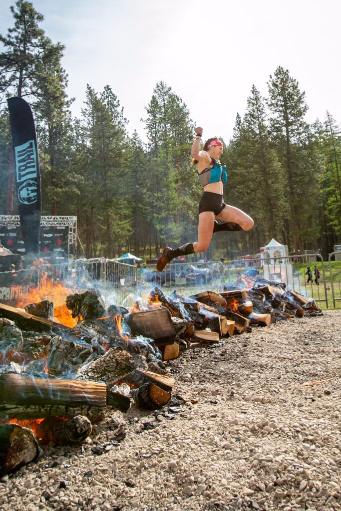 Spartan Hero leaping over a flaming wood pile