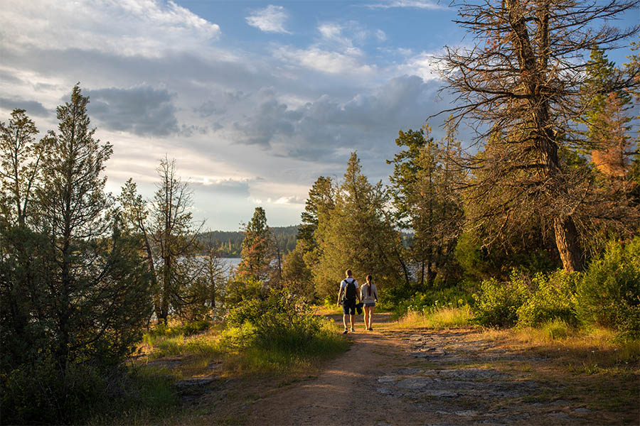 Couple walking a fall trail at Wayfarers State Park on Flathead Lake